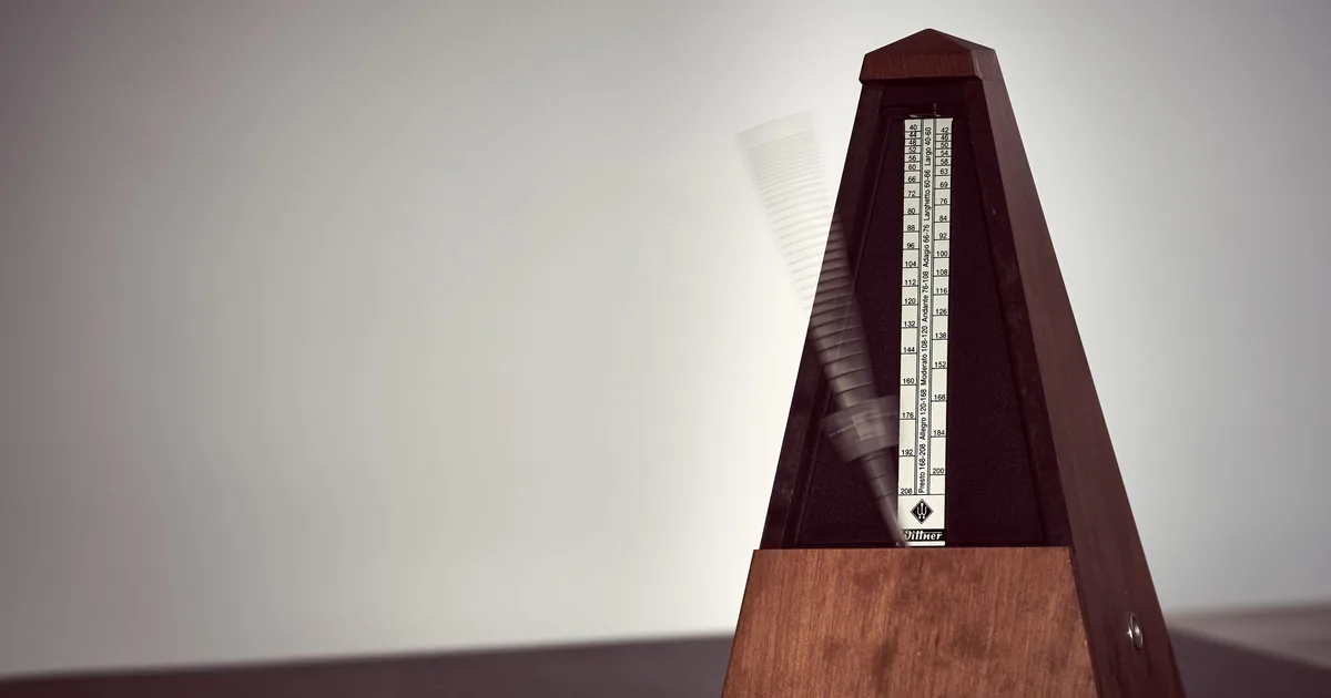 A metronome swinging on a desk, marking the beat of a 4/4 bar while you count one to four out loud