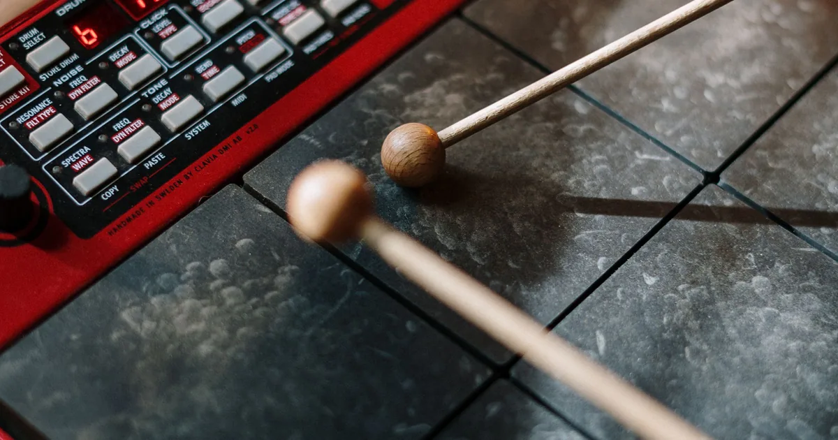 Drumsticks resting on a practice pad, the setup for the matched-grip and single-stroke drills below